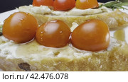 Sandwiches with cottage cheese and cucumber slices, cherry tomatoes on a white farm baguette on a wooden table. Close-up shooting. Стоковое видео, видеограф Ярославский Максим / Фотобанк Лори