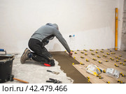 The process of laying floor tiles on the SVP Base, Tile Leveling System. Стоковое фото, фотограф Evgenii Predibailo / Фотобанк Лори