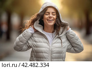 Female model wearing jacket with hood. Generate ai. Стоковое AI-изображение, AI-художник Иван Рябоконь / Фотобанк Лори