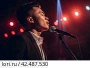 Chinese man singing on microphone. Generate ai. Стоковое AI-изображение, AI-художник Иван Рябоконь / Фотобанк Лори