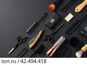 An Assortment of Professional Hairdressing Tools Laid Out on a Dark Surface. Стоковое фото, фотограф Сергей Толмачёв / Фотобанк Лори