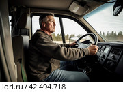 Male truck driver working vehicle cabin. Generate Ai. Стоковое AI-изображение, AI-художник Иван Рябоконь / Фотобанк Лори
