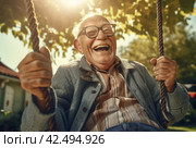 Happy delighted elderly man on swing. Generate ai. Стоковое AI-изображение, AI-художник Иван Рябоконь / Фотобанк Лори