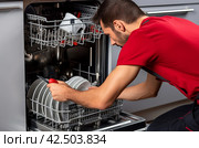 Technician fixing dishwasher. Generate ai. Стоковое AI-изображение, AI-художник Иван Рябоконь / Фотобанк Лори