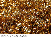 Background of tinsel. Gold spangles festoons hang. Vertical white and black lines. Holiday lights, garlands. Party, celebration, abstract and festive background textures. Foil strips, decoration. Стоковое AI-изображение, AI-художник Aleksandr Golubev / Фотобанк Лори