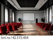 Conference room with red chairs, interior lighting, and empty white insulated screen. Business meetings, conferences, trainings, used as template for elegant design. Interior of the conference hall. Стоковое AI-изображение, AI-художник Aleksandr Golubev / Фотобанк Лори