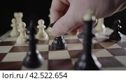 Игра в шахматы. Ход черным конем. Game of chess. Player performs the move black knight. Close-up of hand person. Стоковое видео, видеограф EStarodubov / Фотобанк Лори