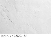 Paper wrinkle background. Texture of luxury white regular paper, capturing the subtle fibers and surface irregularities typical of standard paper. Closeup. Designs decoration, nature backdrop concept. Стоковое AI-изображение, AI-художник Марина Демидюк / Фотобанк Лори