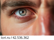 Precise Man holding contact lens closeup. Generate Ai. Стоковое AI-изображение, AI-художник Иван Рябоконь / Фотобанк Лори