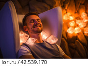 Enlightened Man during crystal healing session in therapy room. Generate Ai. Стоковое AI-изображение, AI-художник Иван Рябоконь / Фотобанк Лори