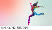A panoramic banner with a dancing girl jumping on a bright colored background. Copy space. Стоковое AI-изображение, AI-художник Ярославский Максим / Фотобанк Лори