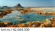 Hot mineral springs in a volcanic area in the desert. Стоковое AI-изображение, AI-художник Евгений Харитонов / Фотобанк Лори