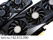 A black and white video card on a white background. Fans and the graphics card case. Computer accessories. Стоковое фото, фотограф Valeriy Lushchikov / Фотобанк Лори