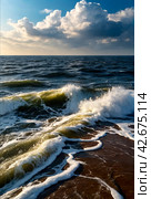 Atmospheric scenery Dramatic Baltic sea, waves and water splashes on breakwaters. Nature north cloudscape on coast ocean. Environment with fickle weather, climate change. Stormy, abstract backgrounds. Стоковое AI-изображение, AI-художник Aleksandr Golubev / Фотобанк Лори