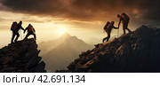 Tourists helping a friend climb a mountain. Panoramic banner. Стоковое AI-изображение, AI-художник Ярославский Максим / Фотобанк Лори
