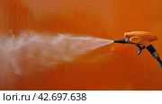 Water Spray Gun Spraying Wall. Стоковое AI-изображение, AI-художник Юлия Гапеенко / Фотобанк Лори