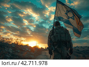 A guy in a soldier's uniform with an Israeli flag in his hand against a cloudy sky. Remembrance Day - Yom HaZikaron, Patriotic holiday, Israeli Independence Day - Yom Ha'atzmaut concept. Стоковое AI-изображение, AI-художник Ирина Михайличенко / Фотобанк Лори