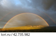 Rainbow on a stormy sky in a mountain valley. Стоковое фото, фотограф Яна Королёва / Фотобанк Лори