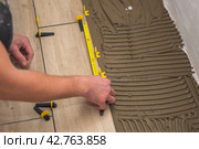 The process of laying floor tiles on the SVP Base, Tile Leveling System. Стоковое фото, фотограф Evgenii Predibailo / Фотобанк Лори