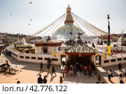 Kathmandu, Nepal - November 17, 2018: People walk around Boudhanath stupa in Kathmandu, Nepal. Редакционное фото, фотограф VittoriaChe / Фотобанк Лори