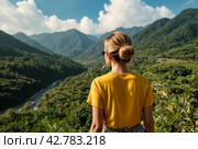 Rear view of lady enjoy at landscape Adam's peak mountain at tropical journey Sri Lanka, Ella, posing. From behind of adult woman in yellow jacket at landmark nature background. Copy ad text space. Стоковое AI-изображение, AI-художник Aleksandr Golubev / Фотобанк Лори