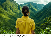 Rear view of lady enjoy at landscape Adam's peak mountain at tropical journey Sri Lanka, Ella, posing. From behind of adult woman in yellow jacket at landmark nature background. Copy ad text space. Стоковое AI-изображение, AI-художник Aleksandr Golubev / Фотобанк Лори
