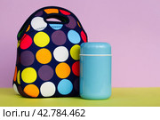 Snack on a break with a lunchbox. colorful handbag, blue thermos. lunch for a schoolboy or an office worker. place for text. Стоковое фото, фотограф Есич Елена / Фотобанк Лори