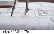The designer draws with a compass and ruler on the drawing. Стоковое видео, видеограф Igor Skripachev / Фотобанк Лори