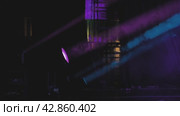 Light equipment on the stage. Purple and blue spotlights on a concert. Bright coloured light shines through smoke. Light and smoke show. Стоковое видео, видеограф Воловодов Владимир / Фотобанк Лори