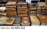 A lot of old books in a book store, flea market, old books. Стоковое AI-изображение, AI-художник Анна Кривицкая / Фотобанк Лори