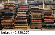 A lot of old books in a book store, flea market, old books. Стоковое AI-изображение, AI-художник Анна Кривицкая / Фотобанк Лори