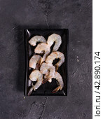 huge sea shrimps on a black plate. View from above. Chinese cuisine, ingredient for hotpot. Стоковое фото, фотограф Abakumova Ekaterina / Фотобанк Лори
