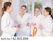 Group of young women are talking after successful and tedious karate workout. Стоковое фото, фотограф Яков Филимонов / Фотобанк Лори