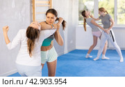Pair self defense training - two teenage girls doing power grabs. Стоковое фото, фотограф Яков Филимонов / Фотобанк Лори