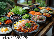 Korean foods served on a dining table. Perfect for photo illustration, article, or any cooking contents. Стоковое AI-изображение, AI-художник Ирина Михайличенко / Фотобанк Лори