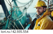 male fisherman in a yellow jacket on an industrial fishing boat against the background of nets and a fishing trawl. Стоковое AI-изображение, AI-художник Александр Довянский / Фотобанк Лори