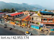 Pokhara, Nepal - November 11, 2018: People walking down the street in the early morning. Редакционное фото, фотограф VittoriaChe / Фотобанк Лори