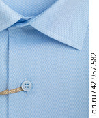 Close-up of a button placket on a light blue diamond shaped mesh shirt. Стоковое фото, фотограф Сергей Чайко / Фотобанк Лори