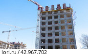 Moscow March 22 2024, Construction site with tower crane. House and buildings construction. Hotel apartments construction. Housing renovation, real estate. Crane on formwork in Built environment. Редакционное фото, фотограф Скрипачев Антон / Фотобанк Лори