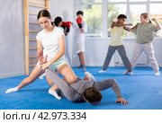 Teenage girl practicing painful armlock in sparring with instructor at self defence training. Стоковое фото, фотограф Яков Филимонов / Фотобанк Лори