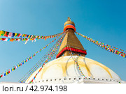 Prayer buddhist flags fluttering in the wind on the Boudhanath stupa in Kathmandu, Nepal (2018 год). Стоковое фото, фотограф VittoriaChe / Фотобанк Лори