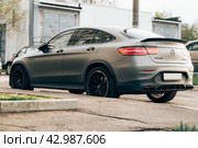 Matte gray Mercedes Benz GLC 63S AMG, rear side view. Photography of a modern premium SUV on parking in Moscow. Редакционное фото, фотограф Константин Григорьев / Фотобанк Лори