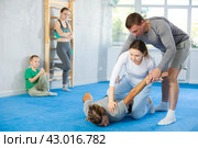 Woman student, with help of male teacher, completes neutralization of opponent. Стоковое фото, фотограф Яков Филимонов / Фотобанк Лори