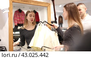 Man with wife participate in inspection of goods, help determine choice of skirt. Стоковое видео, видеограф Яков Филимонов / Фотобанк Лори