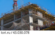 Moscow March 22 2024. . Housing renovation, real estate. Crane on formwork in Built environment. Cranes on pouring concrete. Tower crane on the construction site of a block of flats of the monolithic residential apartment building. Редакционное фото, фотограф Скрипачев Антон / Фотобанк Лори