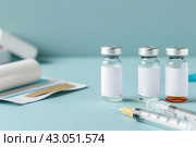 Syringe and glass vial on blue background table. Medical Vials group, needles, ampoules, bottle with medicines or vaccine. Disease treatment. Creative Banner. Anti-aging beauty injections. Vaccination. Стоковое AI-изображение, AI-художник Марина Демидюк / Фотобанк Лори