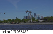 The Luzhniki cable car across the Moskva River against the backdrop of the skyscrapers of Moscow City. Russia. Moscow. 01.05.24 (2024 год). Редакционное видео, видеограф Ярославский Максим / Фотобанк Лори