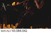 Atmospheric video of a musician playing the cello surrounded by numerous candles. The scene creates a serene and calm atmosphere reflecting the harmony and melody of the music. Стоковое видео, видеограф Воловодов Владимир / Фотобанк Лори