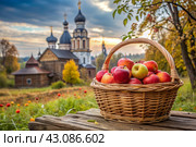 The concept of the Russian Orthodox holiday yablochny spas. A beautiful wicker basket made of vines with red ripe apples on the background of an Orthodox church. Стоковое AI-изображение, AI-художник Photojuli / Фотобанк Лори