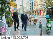 Antalya Coronavirus Protective Measures, two elderly men wear protective face masks on their way home just before curfew. (2021 год). Стоковое фото, фотограф Владимир Григорьев / Фотобанк Лори